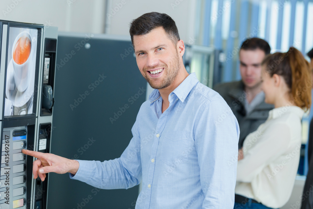 a man usinga vending machine a man usinga vending machine
