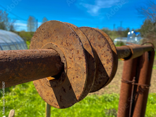 Rusty iron metal industrial pipe of large diameter old with holes for pumping liquid and construction in an oil refinery, petrochemical plant