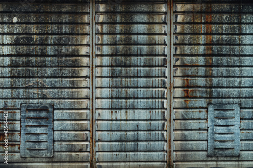 Worn corrugated steel plate garage wall as background