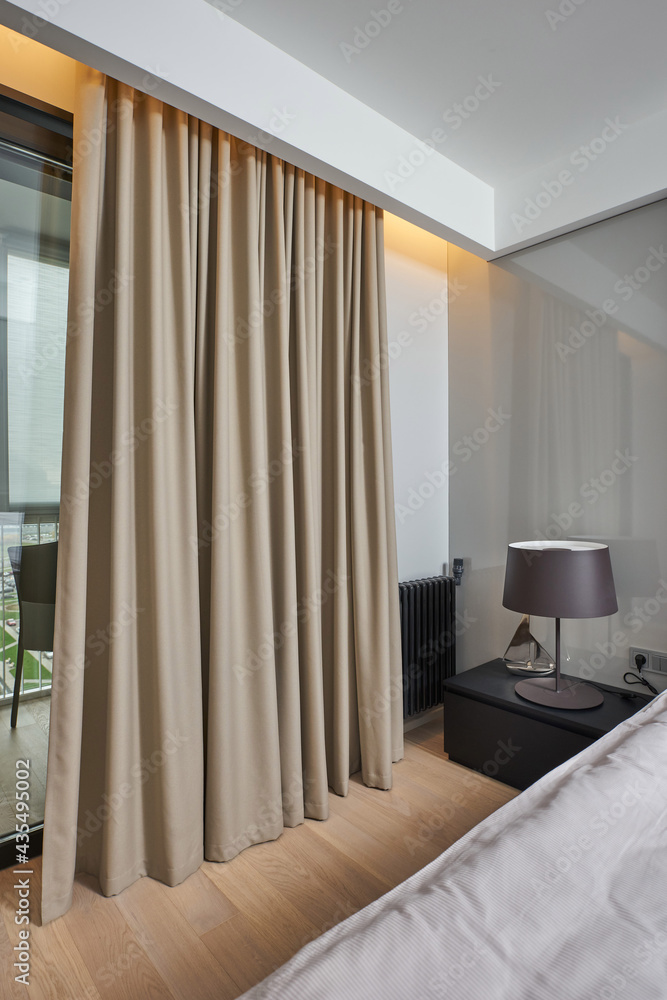 a bed with a soft headboard and lamps on the bedside tables in the hotel room a bed with a soft headboard and lamps on the bedside tables in the hotel room