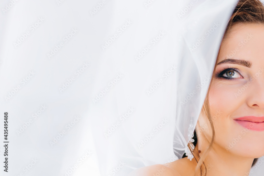 beautiful bride with a veil on her head looks up smiling, happiness, love. beautiful bride with a veil on her head looks up smiling, happiness, love.