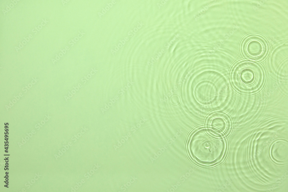 De-focused closeup of mint green transparent clear water surface texture with ripples, splashes and bubbles. Trendy abstract summer nature background. Mint colored waves in sunlight with copy space. De-focused closeup of mint green transparent clear water surface texture with ripples, splashes and bubbles. Trendy abstract summer nature background. Mint colored waves in sunlight with copy space.
