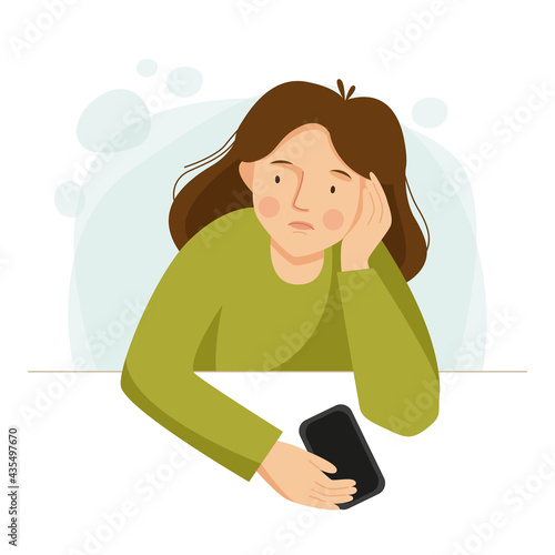 Sad girl is sitting with the phone. The woman has problems. 