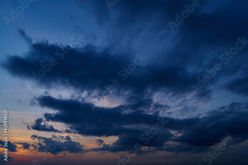 beautiful sunset sky, dark silhouette of clouds as a background © soleg