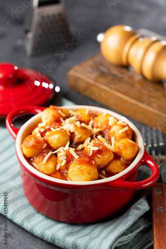 Gnocchi with tomato sauce and grated Parmesan cheese.