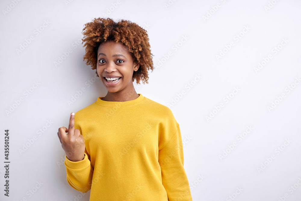 Portrait of excited afro american woman making fuck you sign. Naughty concept. Fuck off. Isolated White Background Portrait of excited afro american woman making fuck you sign. Naughty concept. Fuck off. Isolated White Background