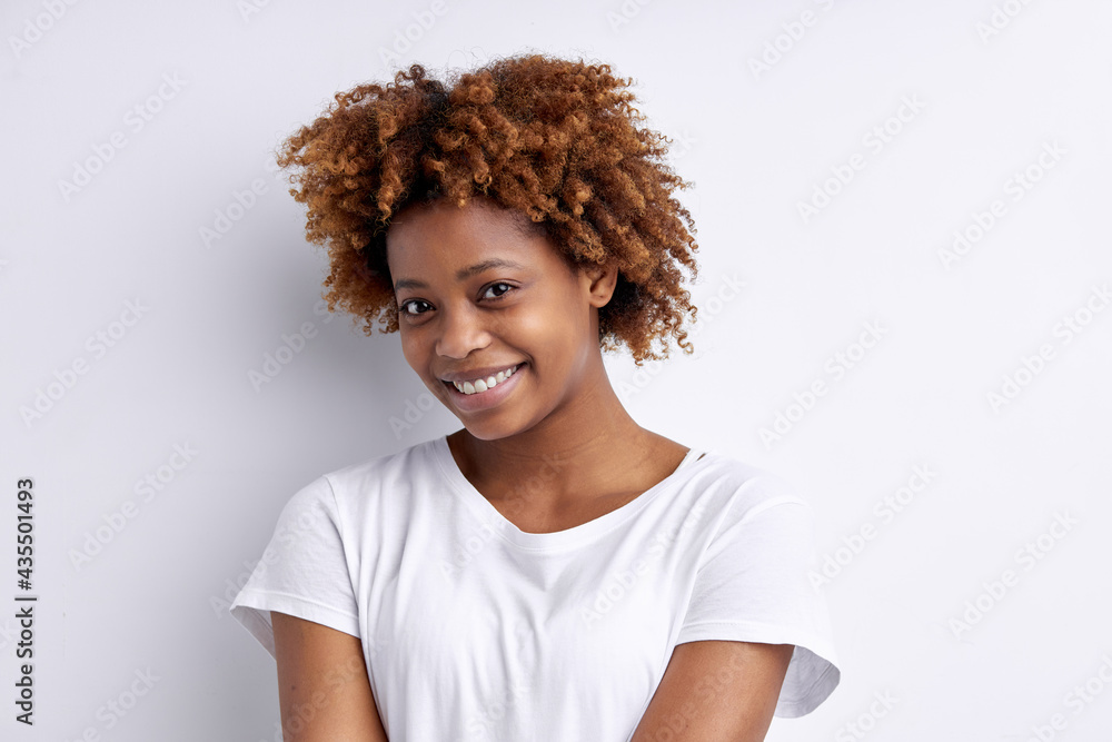 Cute Pretty Afro American Lady With Curly Hair Posing Looking At Camera, Wearing Casual T-Shirt, Isolated On White Studio Background Cute Pretty Afro American Lady With Curly Hair Posing Looking At Camera, Wearing Casual T-Shirt, Isolated On White Studio Background