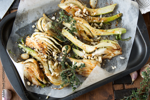flat lay baking sheet with baked fennel with garlic and thyme close-up