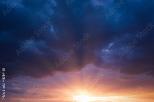 Cancer blue stormy sky with sun rays. © maykal