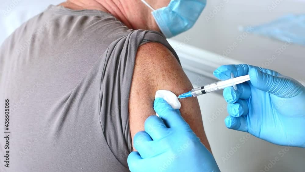 Elderly Man in Face Mask getting Covid Vaccine. Doctor giving Injection to senior Man at Hospital. Virus, COVID-2019 Flu protection. Vaccination of old Patient in a Clinic during Coronavirus pandemic. Elderly Man in Face Mask getting Covid Vaccine. Doctor giving Injection to senior Man at Hospital. Virus, COVID-2019 Flu protection. Vaccination of old Patient in a Clinic during Coronavirus pandemic.