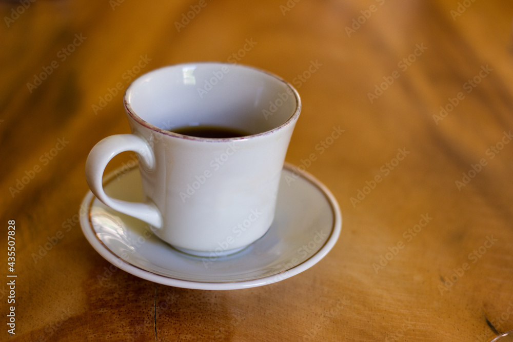 Cup of organic coffee on a wooden table at Cup of organic coffee on a wooden table at