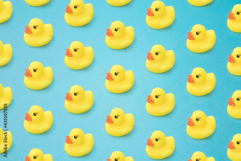 Arranged yellow rubber duck on a blue background.