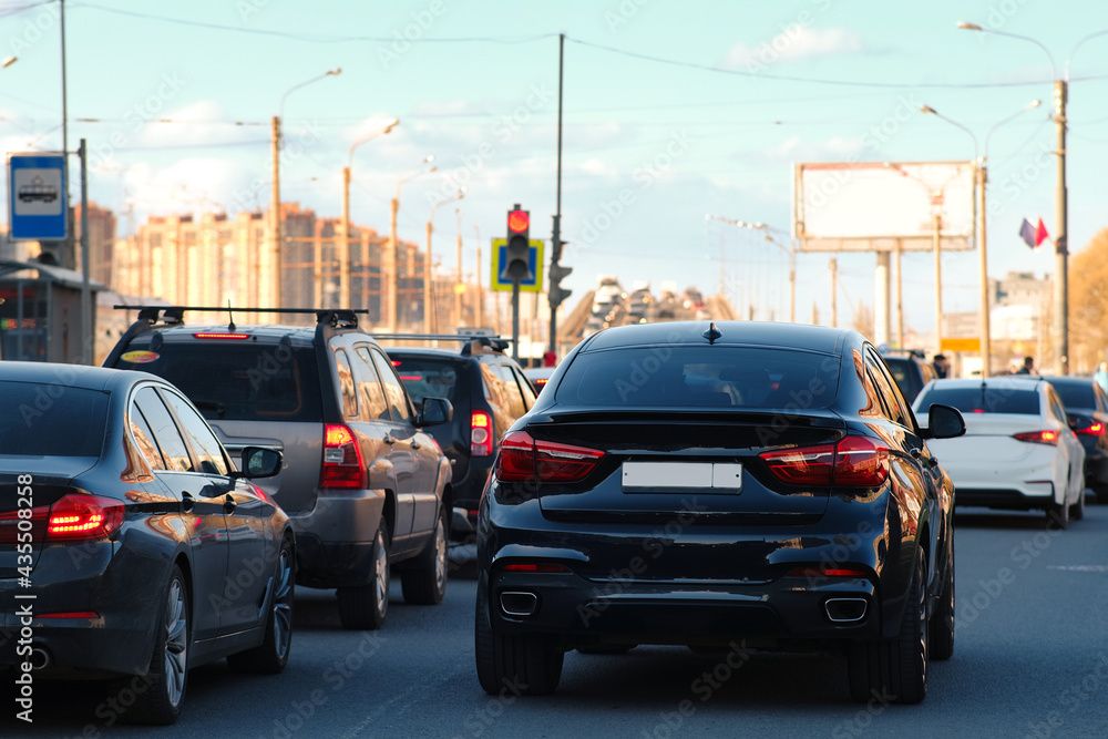 Background, blur, out of focus, bokeh. Traffic jams during rush hours after work. Red brake lights of stopped cars on the background of the city neighborhood.