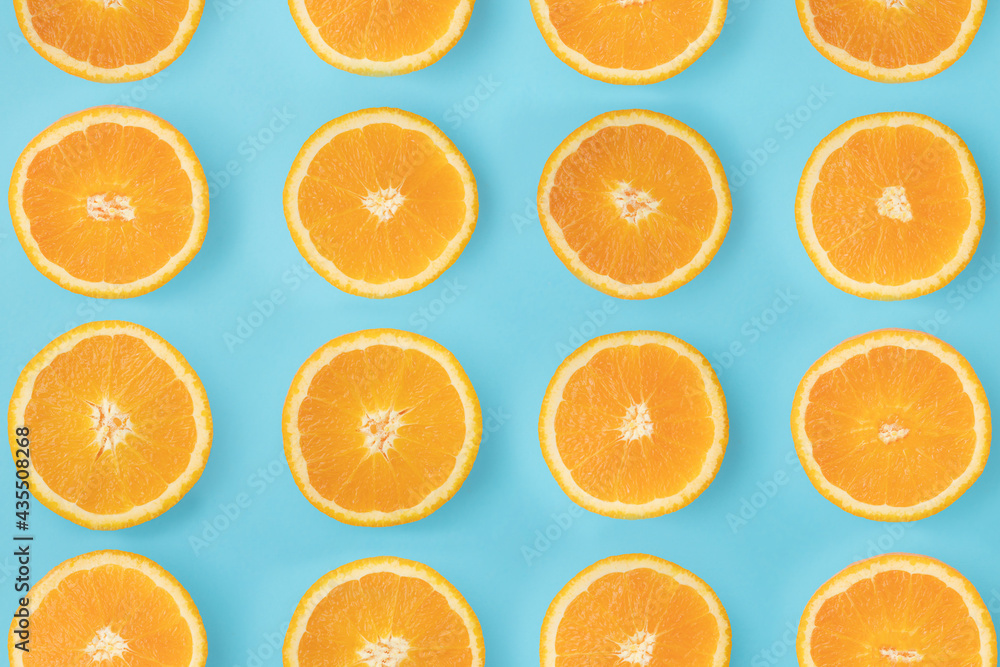 Arranged sliced orange. Slices lined up on a blue background. Arranged sliced orange. Slices lined up on a blue background.