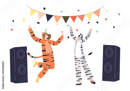 Joyful man and woman dressed in tiger and zebra kigurumi jumpsuit dance on pajama overnight party