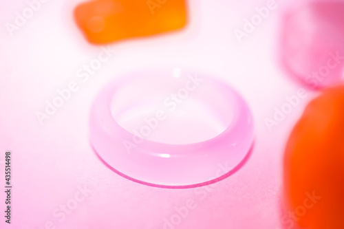 Pink semi-precious stone ring on a pink background. There is a place for text.