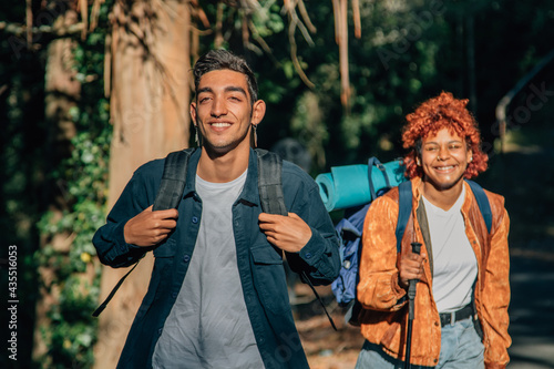 young travelers hiking with backpack outdoors