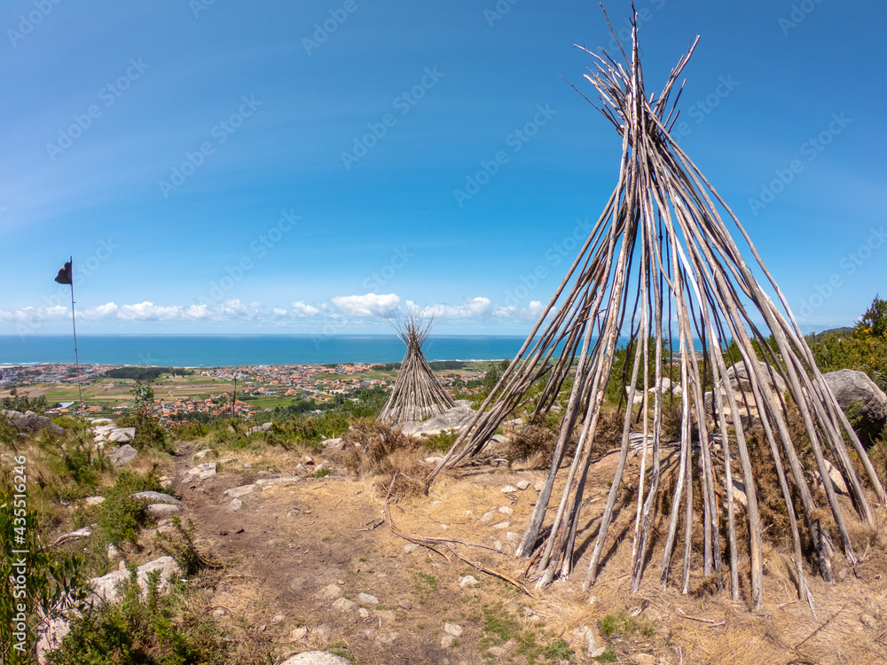 The Patio das Cabanas (Huts Courtyard) in Vila Cha, Esposende, Portugal. Wooden stick hut house, looking like Indian tepee with a beautiful panorama view towards the Portuguese coastline.