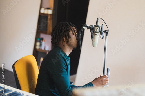 Man holding and singing into microphone