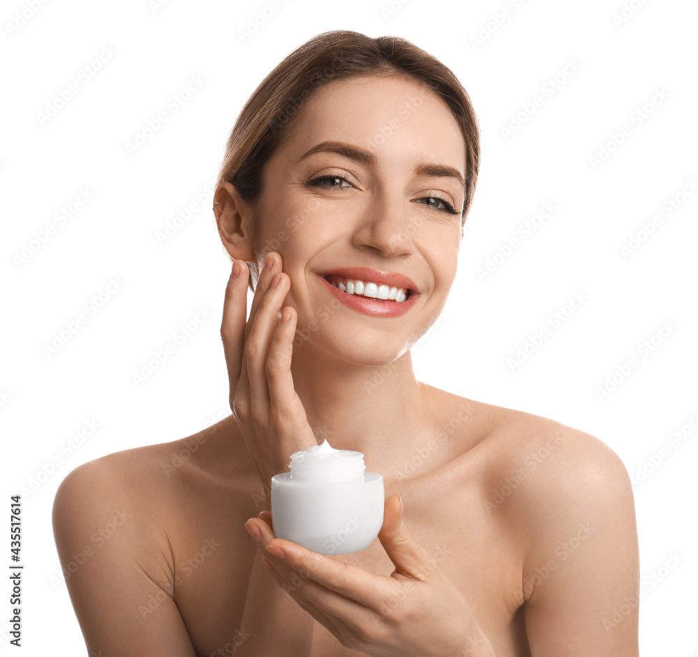 Young woman applying facial cream on white background Young woman applying facial cream on white background