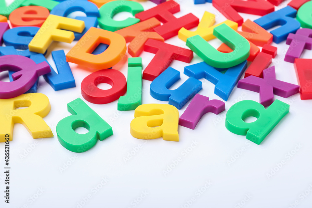 Many colorful magnetic letters on white background Many colorful magnetic letters on white background