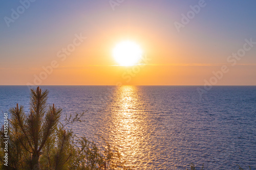 Walkway in the sea from the sun at sunset. Seascape. Summer vacation and travel