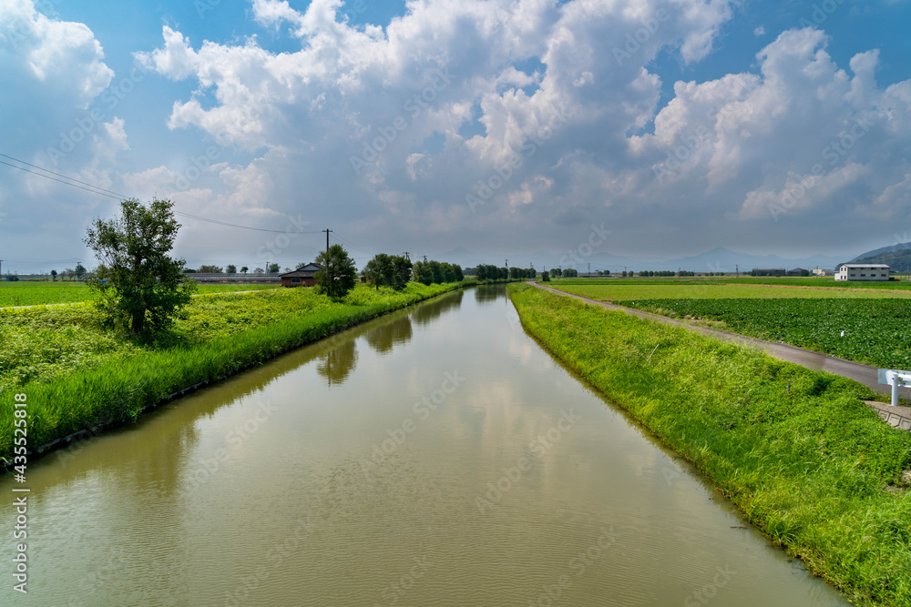 irrigation canal runs through the countryside in Saga prefecture, JAPAN.