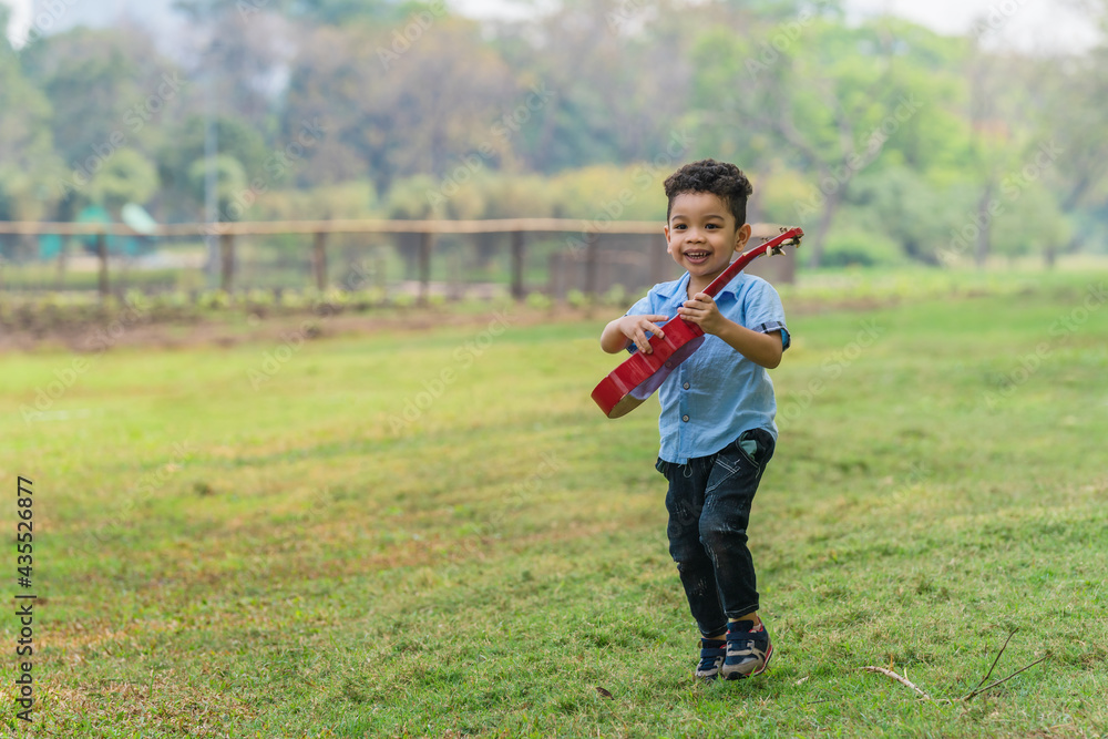 Fototapeta premium mixed race caucasian and asian boy having fun playing in park