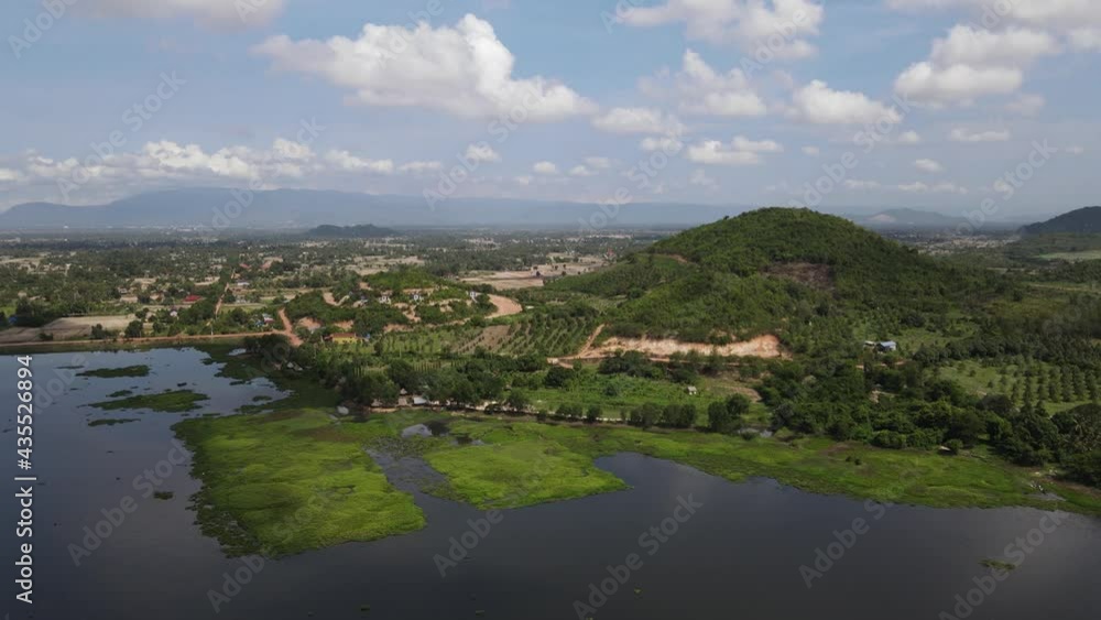 Beautiful and stunning nature around the secret lake in kampot province, Cambodia. Drone showing the surface of the lake and nature around, surrounded by green mountains Beautiful and stunning nature around the secret lake in kampot province, Cambodia. Drone showing the surface of the lake and nature around, surrounded by green mountains