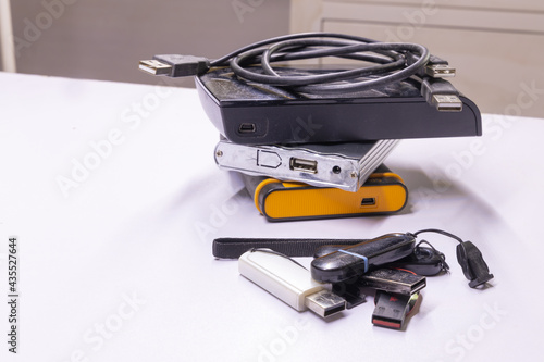 Hard discs and Pen drives also called flash drives used to store data from computer stacked together 