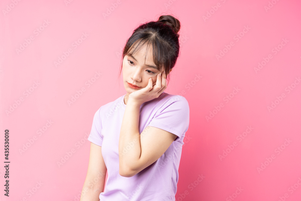 Portrait of depressed girl, isolated on pink background Portrait of depressed girl, isolated on pink background