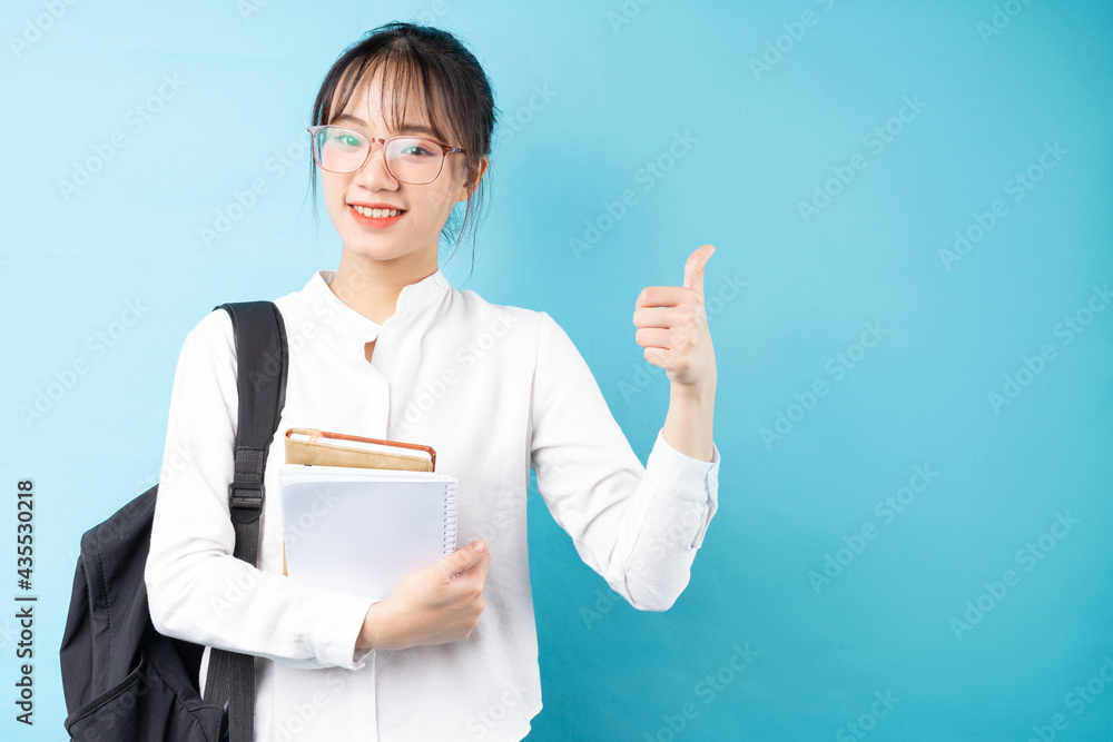 Portrait of a beautiful schoolgirl on a blue background Portrait of a beautiful schoolgirl on a blue background