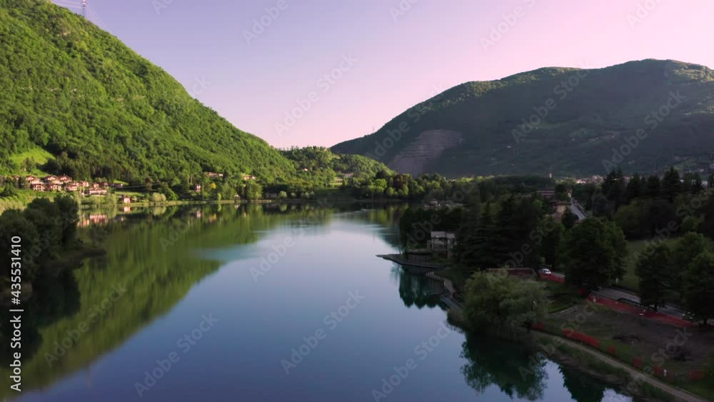 Drone flying over Lake Endine, Lombardy, Italy. Aerial view of charming Italian villages seen from the sky, with the mountains in the background Drone flying over Lake Endine, Lombardy, Italy. Aerial view of charming Italian villages seen from the sky, with the mountains in the background
