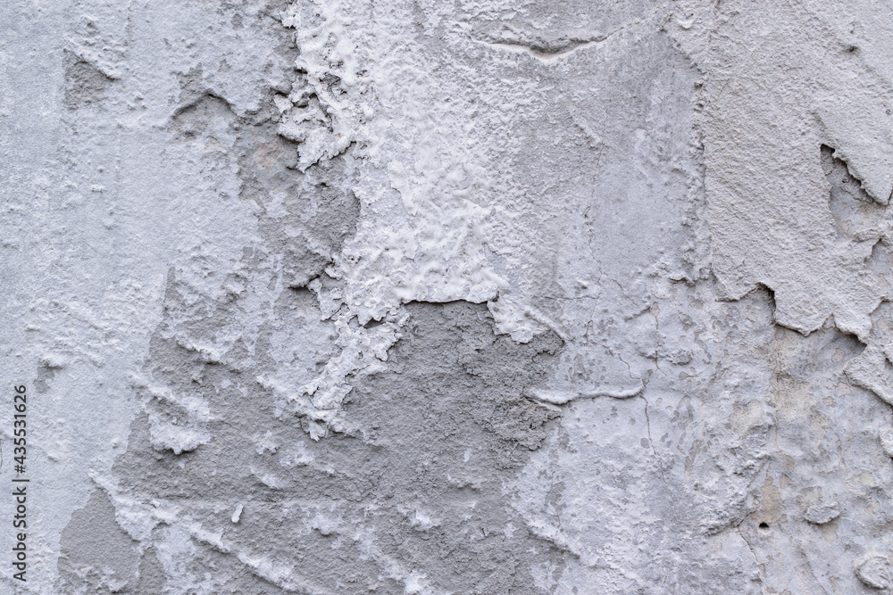 Gray wall with cement plaster. Detachments, cracks, irregularities. Gray wall with cement plaster. Detachments, cracks, irregularities.