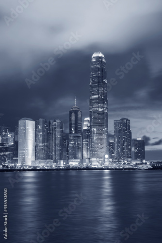 Skyline and harbor of Hong Kong city at dusk