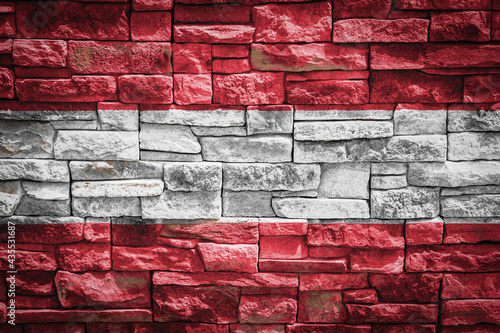 National flag of Austria on stone wall background.The concept of national pride and symbol of the country. Flag banner on stone texture background.