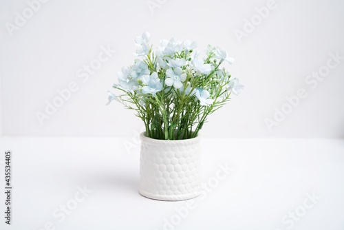 Fake flower pots in a vase on white background, Plastic flower © tong2530