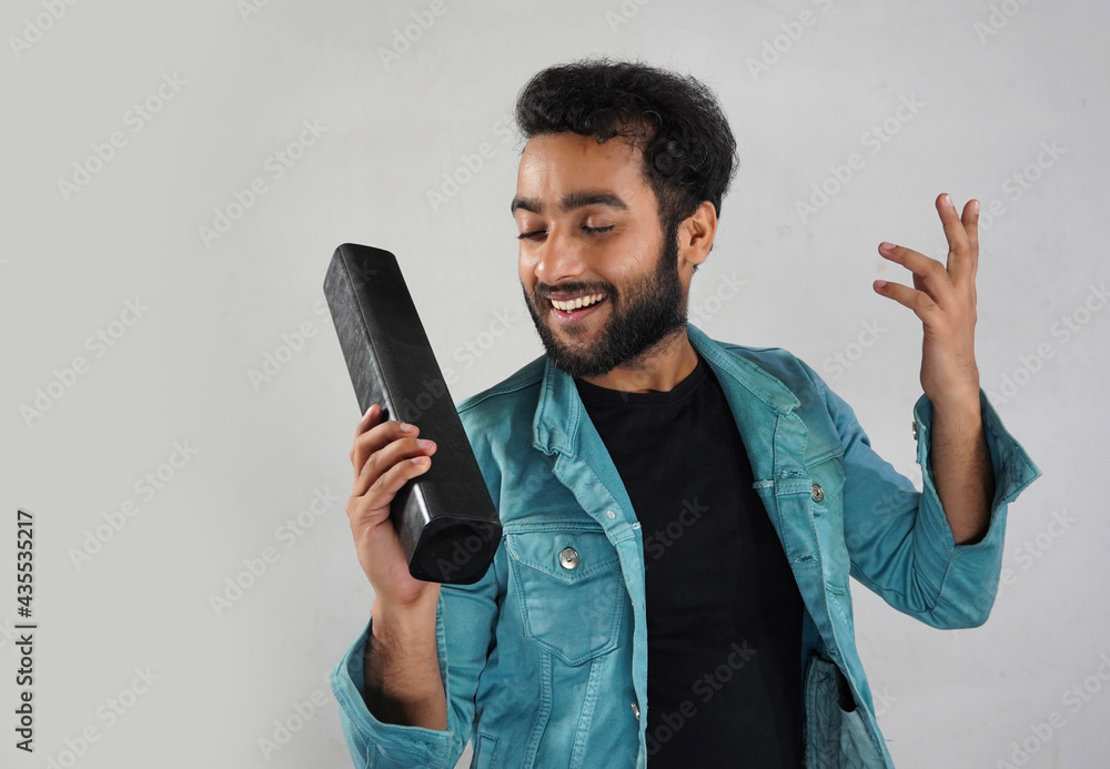 Image of a man with sound bar he's listening music and happy Image of a man with sound bar he's listening music and happy