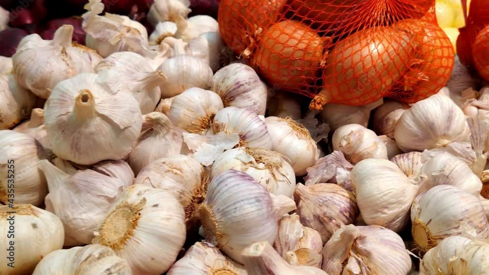 Stack of garlic and onion in grocery store. Industry of selling products Stack of garlic and onion in grocery store. Industry of selling products