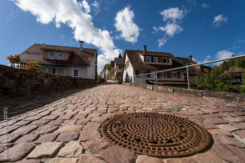 red sandstone walk on hill with manhole cover