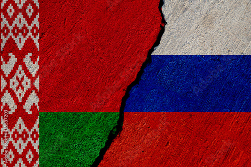 belarus and russia flags painted on cracked concrete wall