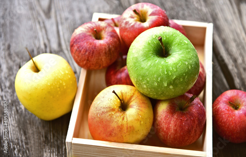 colorful of 3 Type of apple,Gala,Granny Smith,Golden Delicious in wooden box and wooden background.