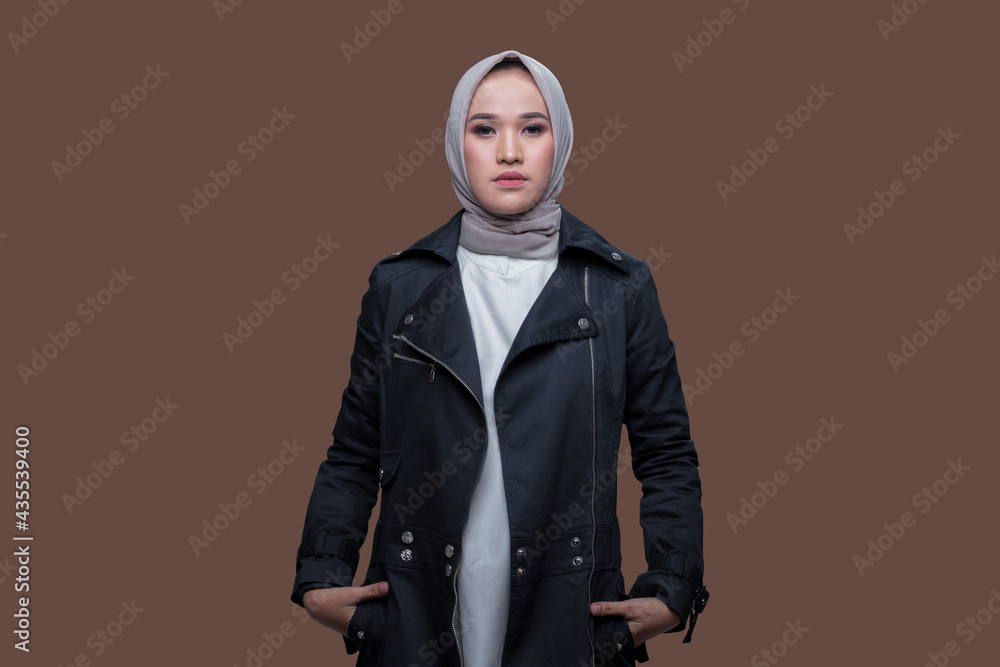 Cool woman wearing hijab posing on plain background 