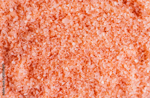 Pink sea salt close-up. The texture of salt crystals. The background is made of natural ingredients.