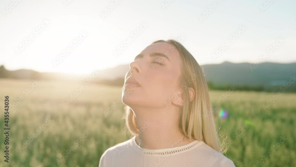 Close up shot of young woman with closed eyes enjoying sunbeams in rural nature Close up shot of young woman with closed eyes enjoying sunbeams in rural nature