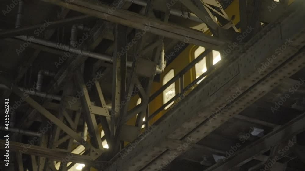 Slow Motion Pan Of An Elevated Subway Metro Train As It Passes By, Surrounded By Steel Girders And Framing - Berlin, Germany Slow Motion Pan Of An Elevated Subway Metro Train As It Passes By, Surrounded By Steel Girders And Framing - Berlin, Germany