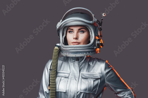 Woman astronaut wearing space helmet and suit Fototapeta