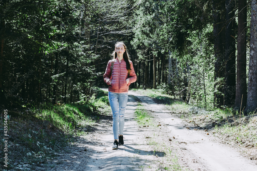 Lonely one girl walk in the road forest summer spring background, Relax time on holiday concept travel. Lonely one girl walk in the road forest summer spring background, Relax time on holiday concept travel.