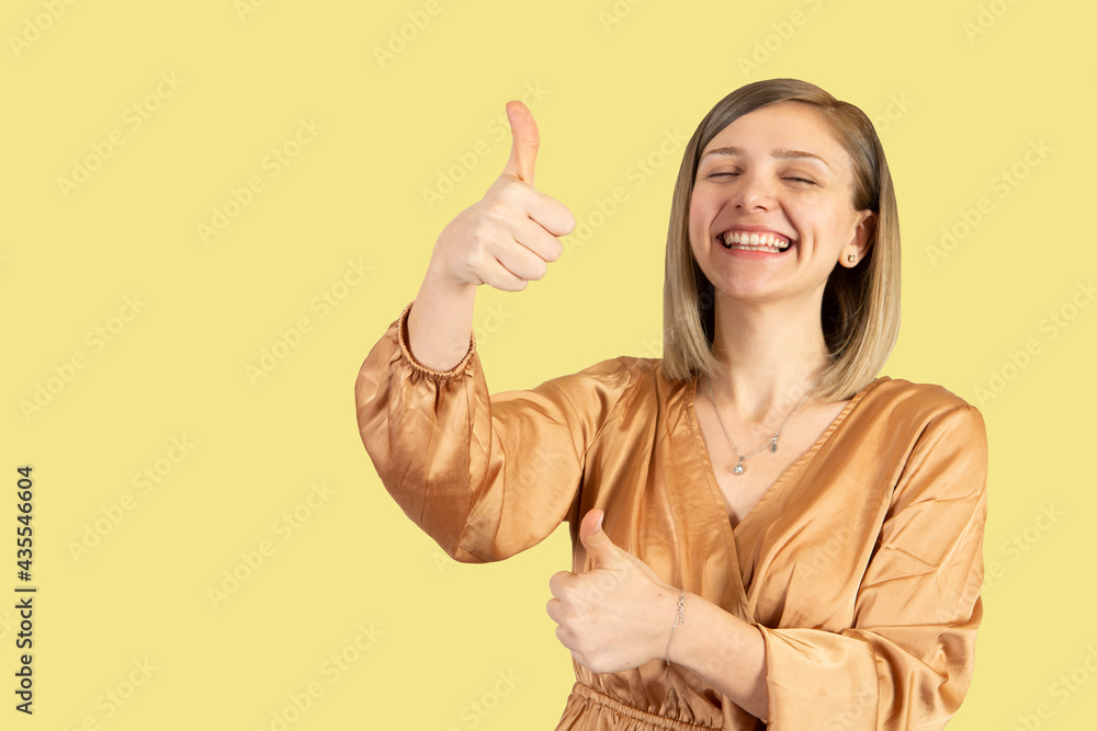 blonde beautiful girl giving thumbs up and smiling great job blonde beautiful girl giving thumbs up and smiling great job