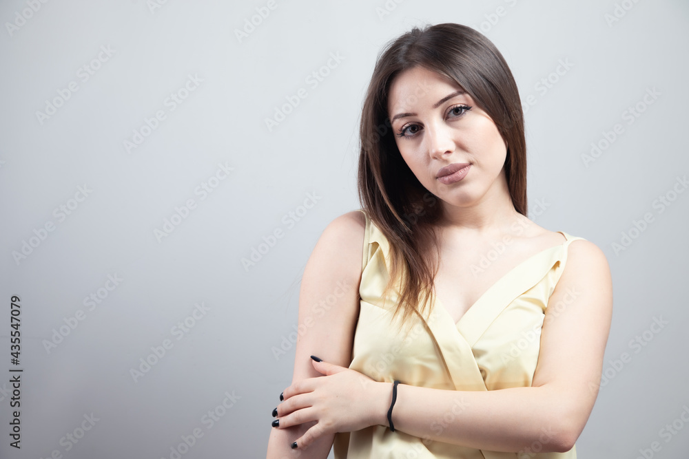Fototapeta premium Beautiful young woman with bare shoulders looks at the camera